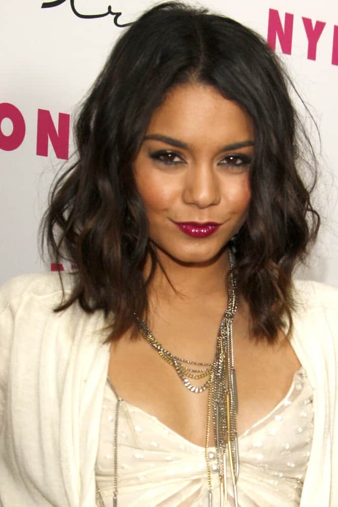Vanessa Hudgens attended the Nylon Magazine 12th Anniversary Issue Party at Tru Hollywood on March 24, 2011 in Los Angeles, CA. She wowed everyone with her all-white outfit and shoulder-length tousled wavy hairstyle with subtle highlights.