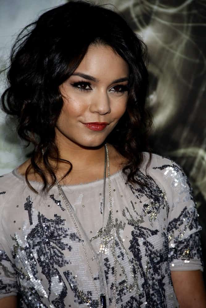 Vanessa Hudgens wore a silver sequined outfit that went quite well with her tousled curly raven hairstyle that has long curly side bangs at the Los Angeles Premiere of "Sucker Punch" held at the Grauman's Chinese Theater in Los Angeles, California on March 23, 2011.