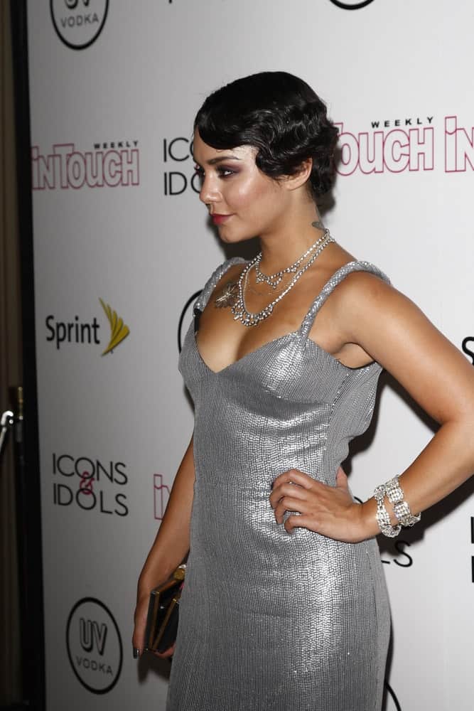 Vanessa Hudgens wore a gorgeous silver dress that she wore confidently with her slick short raven hairstyle that has a vintage curl on the side at the 4th annual Icons & Idols party at the Sunset Tower Hotel in West Hollywood, California on August 28, 2011.