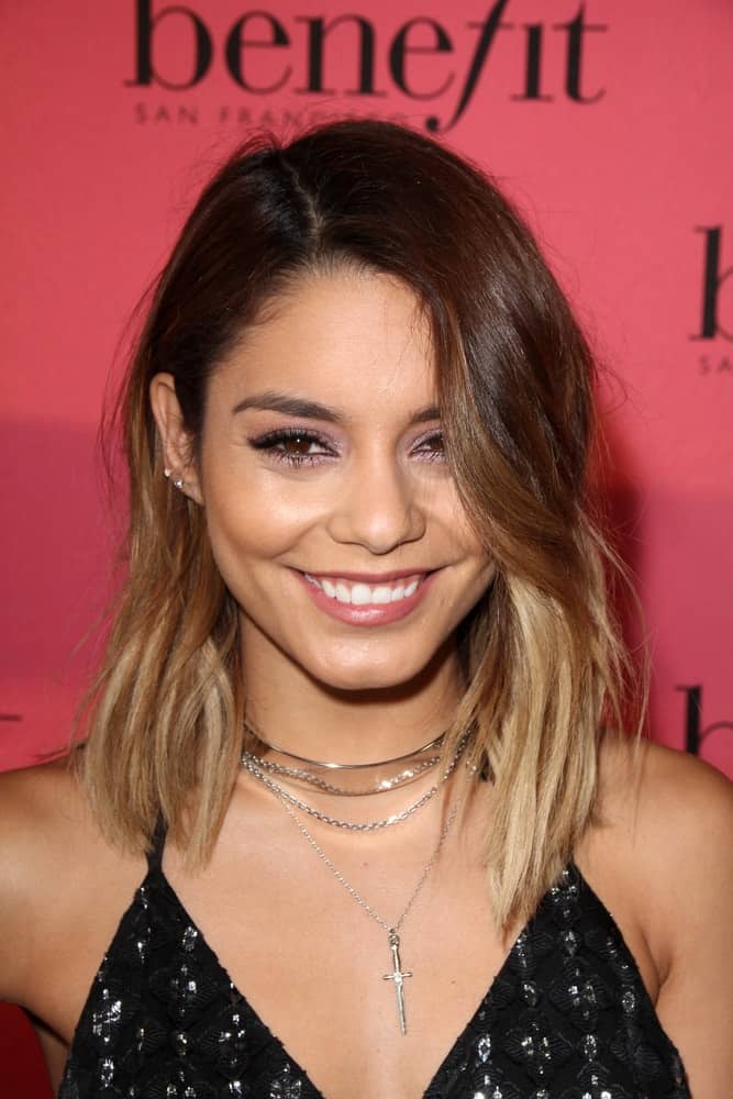 Vanessa Hudgens's charming and bright smile went quite well with her shoulder-length highlighted loose hairstyle that has wavy side-swept bangs at the Benefit Cosmetics Kicks Off Wing Women Weekend at Space 15 Twenty on September 26, 2014 in Los Angeles, CA.