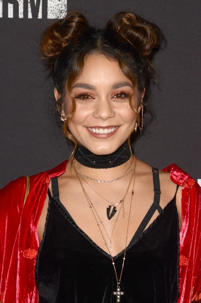 Vanessa Hudgens swept up her long hair into an upstyle with two buns at the top that has highlights and loose tendrils at the 2016 Knott's Scary Farm at Knott's Berry Farm on September 30, 2016 in Buena Park, CA.