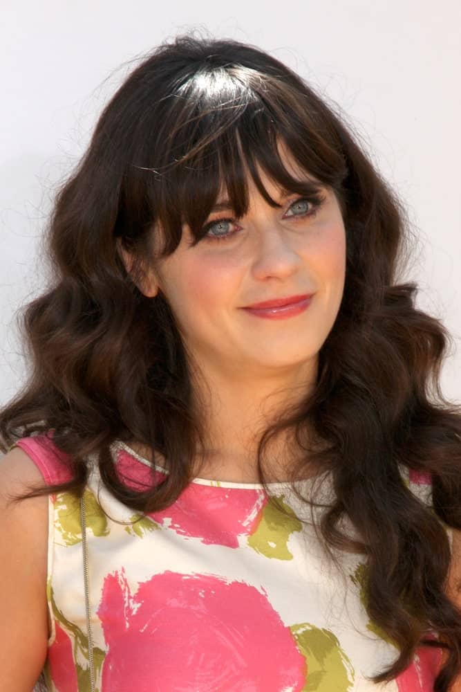Zooey Deschanel was at the "Winnie, the Pooh" Premiere at Walt Disney Studios on July 10, 2011 in Burbank, CA. She paired her lovely floral dress with a long and wavy dark hairstyle that is loose and tousled.