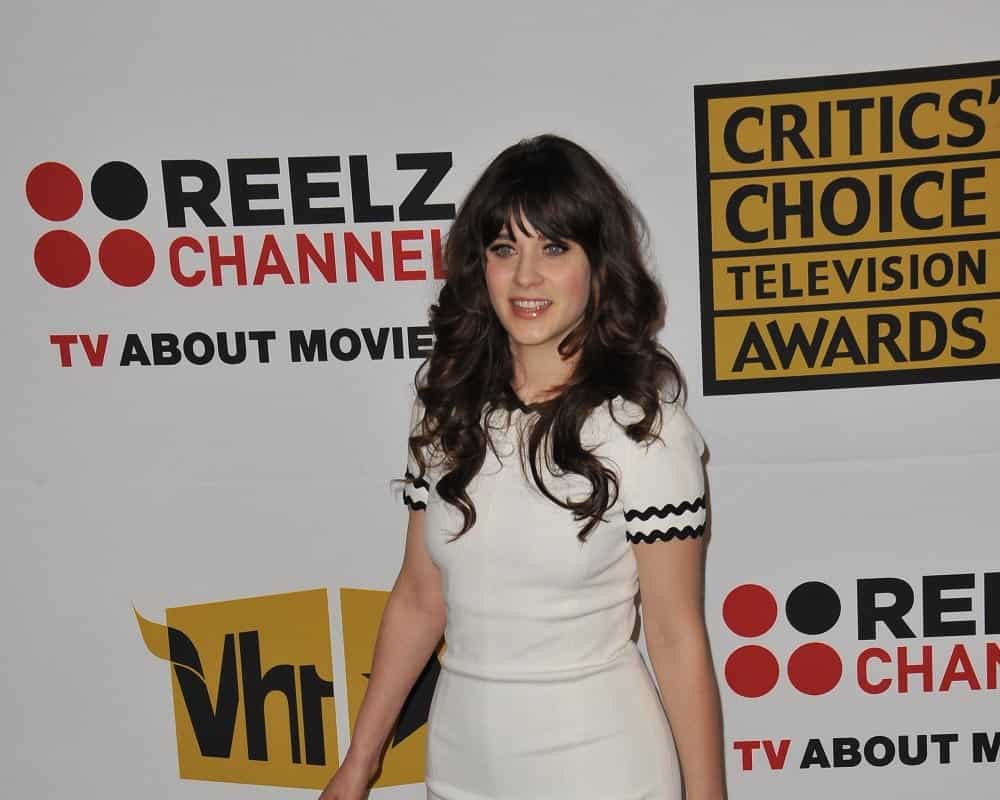 Zooey Deschanel was at the 2011 Critics' Choice Television Awards at the Beverly Hills Hotel on June 20, 2011 in Beverly Hills, CA. She paired her lovely white dress with a long and wavy dark hairstyle that is tousled and layered.