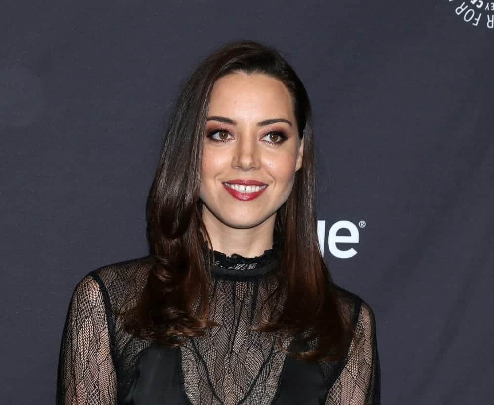 Aubrey Plaza was at the PaleyFest - "Parks and Recreation" 10th Anniversary Reunion at the Dolby Theater on March 21, 2019, in Los Angeles, CA. She was sexy and stunning in a black sheer dress that she paired with her long and loose tousled raven hairstyle with layers and long side bangs.