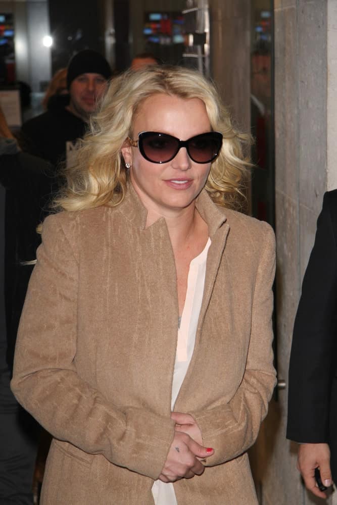 Britney Spears was seen leaving the BBC radio one studios on Oct 16, 2013 in London with tousled curly hair and black shades.