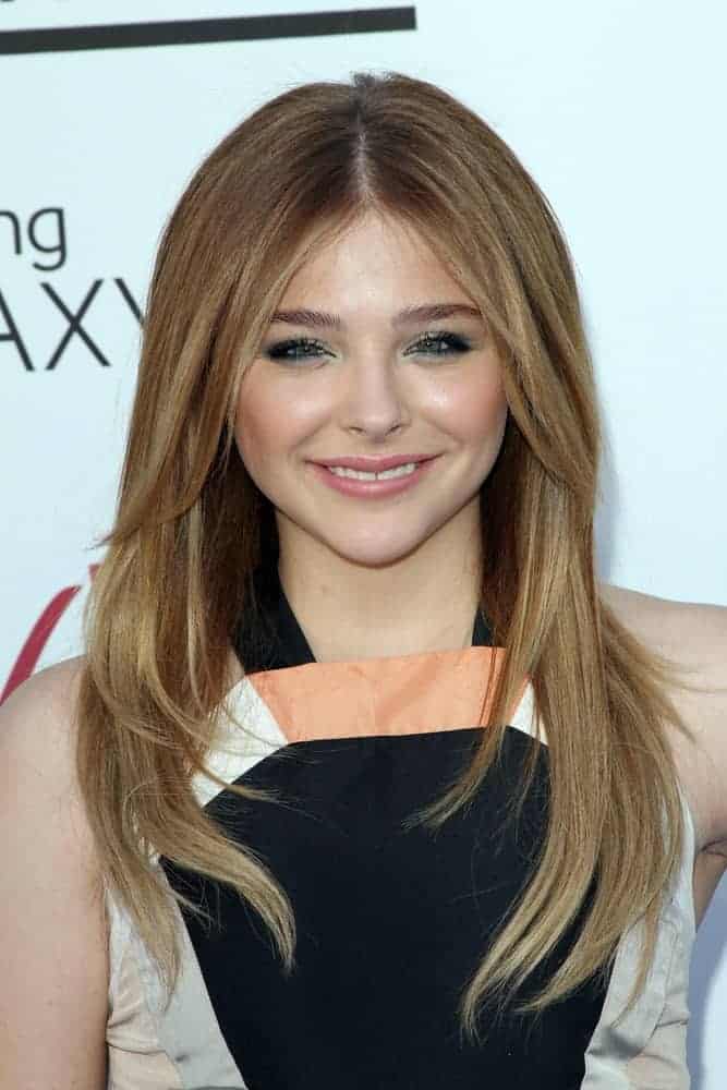 Chloe Grace Moretz was at the 2013 Billboard Music Awards held at the MGM Grand, Las Vegas, NV on May 19, 2013. She was lovely in her colorful dress and long layered brunette hairstyle that has long side bangs.