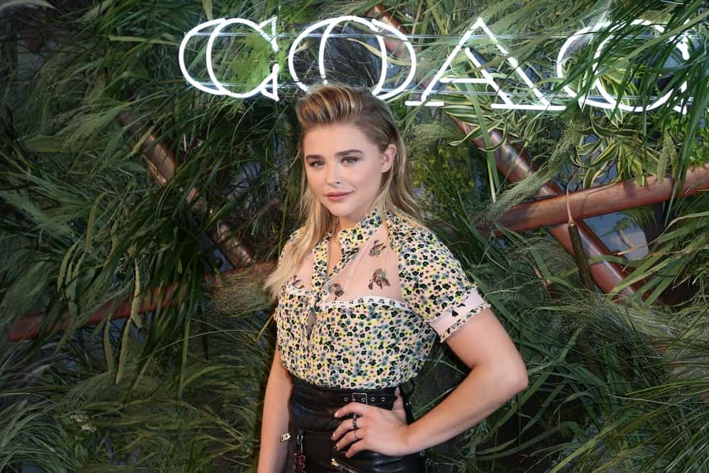 Chloe Grace Moretz attended the 2016 Coach And Friends Of The High Line Summer Party at The High Line on June 22, 2016 in New York City. She was lovely in a blouse and leather skirt to pair with her edgy pompadour style highlighted upstyle hair.