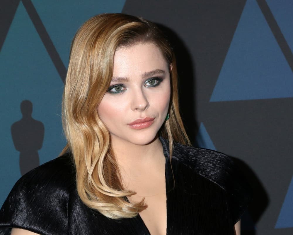 Chloe Grace Moretz was at the 10th Annual Governors Awards at the Ray Dolby Ballroom on November 18, 2018 in Los Angeles, CA. She wore an all-black dress to pair with her side-swept wavy sandy blond hairstyle with a slick finish.
