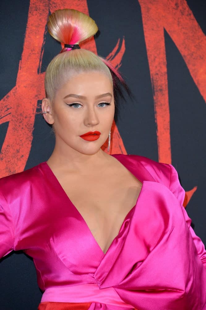 Christina Aguilera tied her blonde hair with black and pink highlights into a top knot at the world premiere of Disney's "Mulan" on March 9, 2020.