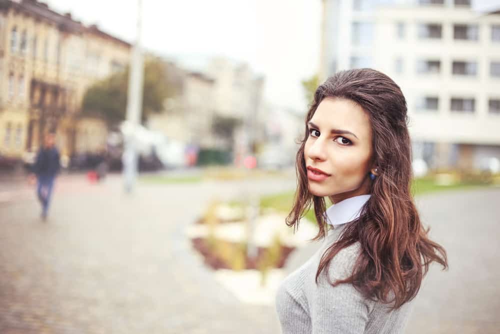 Woman with hair half up and half down