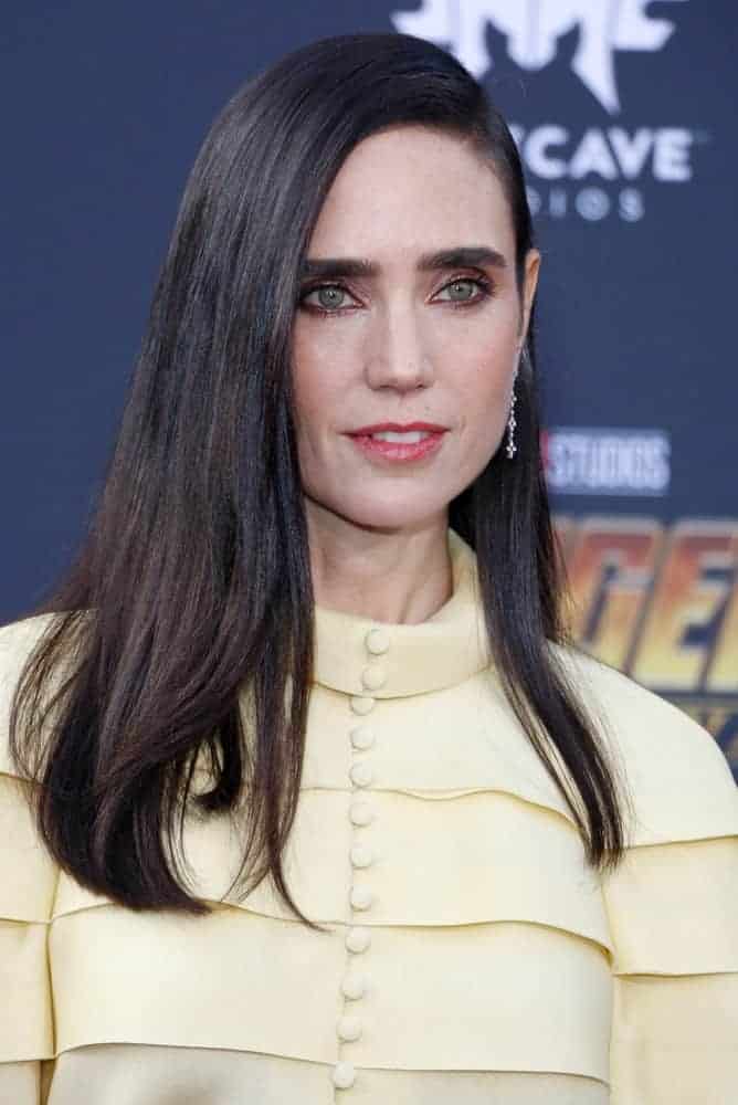 Jennifer Connelly was at the premiere of Disney and Marvel's 'Avengers: Infinity War' held at the El Capitan Theatre in Hollywood on April 23, 2018. She was seen wearing a yellow blouse with her long and tousled dark hair with long side-swept bangs.