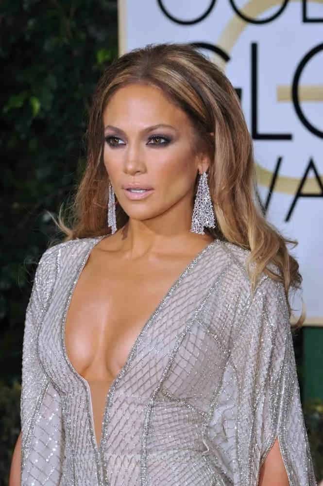 JLo's loose center-part curls hairstyle adds attitude to her dramatic looks at the 72nd Annual Golden Globe Awards on January 11, 2015.