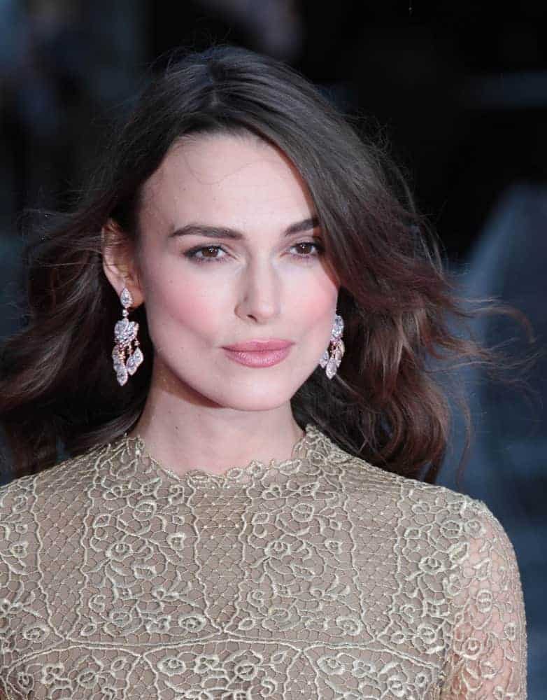 Keira Knightley attended the opening night gala of the 58th BFI London Film Festival at Odeon Leicester Square on Oct 8, 2014, in London. She was elegant in her beige patterned dress and her hair was long, tousled, loose, and layered with side-swept longs bangs.