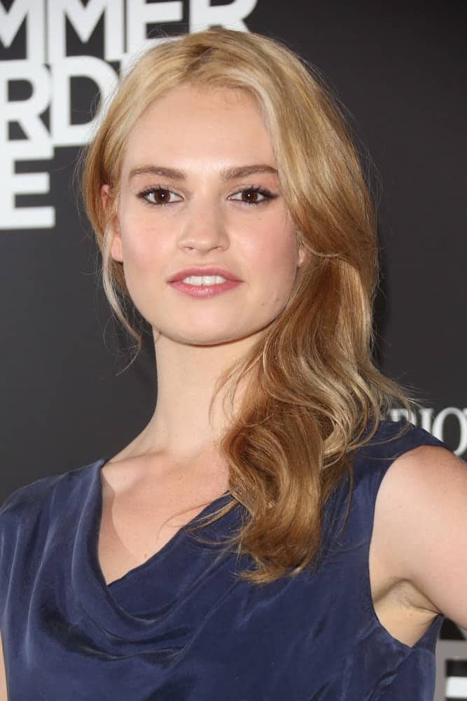 Lily James was at the Emporio Armani Summer Garden Live 2013, London on July 16, 2013. She was seen wearing a charming blue dress to pair with her medium-length side-swept ombre sandy blonde hairstyle with waves and layers.
