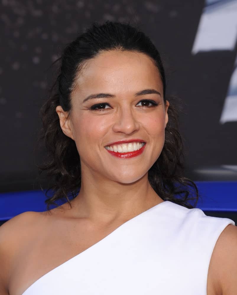 Michelle Rodriguez gathered her shoulder-length curls in a slicked back half updo during the "Fast & Furious 6" US Premiere on May 21, 2013.