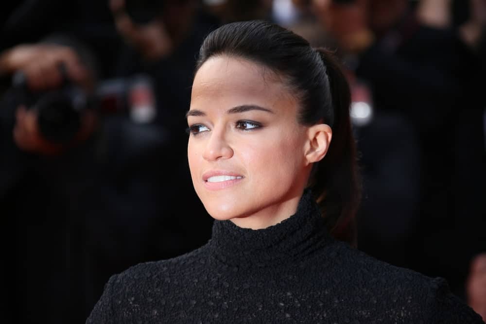 On May 24, 2015, Michelle Rodriguez was seen at the closing ceremony and ‘Le Glace Et Le Ciel’ Premiere during the 68th annual Cannes Film Festival. She was wearing an all-black dress that’s matched with a neat ponytail hairstyle.