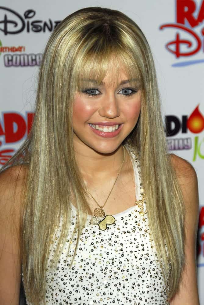 Miley Cyrus wore her iconic Hannah Montana look of straight blond hair with blunt bangs at the Radio Disney Totally 10 Birthday Concert on July 22, 2006 at Anaheim Pond in Anaheim, CA.