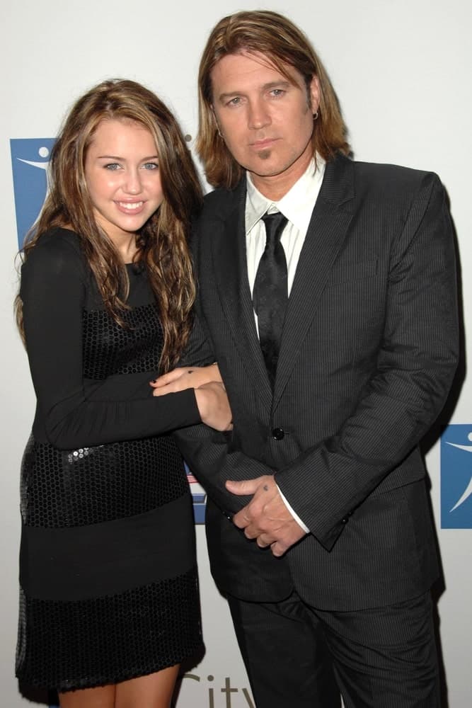 Miley Cyrus and her father were at the 2007 Spirit Of Life Awards Dinner hosted by Hilary Duff at the Pacific Design Center in West Hollywood, CA. Miley wore a lovely black dress with her long and layered hairstyle.