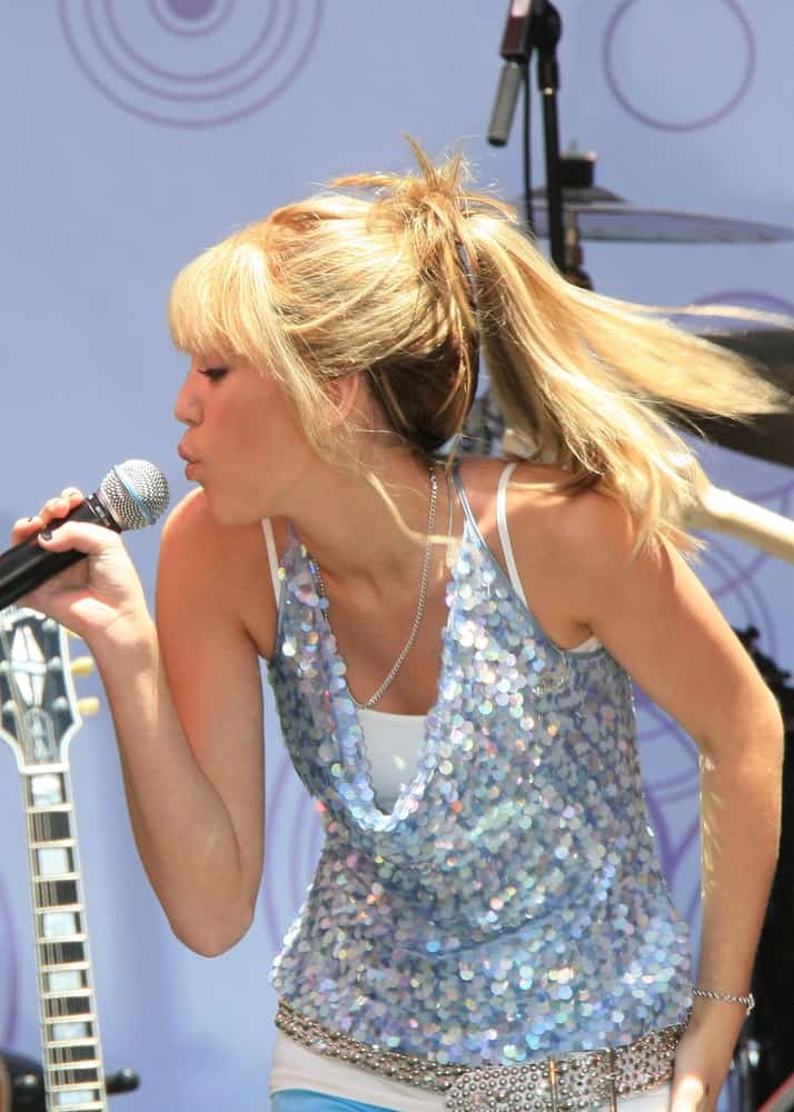 Miley Cyrus wore her iconic blond locks in a ponytail with bangs at the Disney Channel free concert by Miley Cyrus to celebrate the DVD release of "Hannah Montana: Pop Star Profile" in Los Angeles, California on June 26, 2007.
