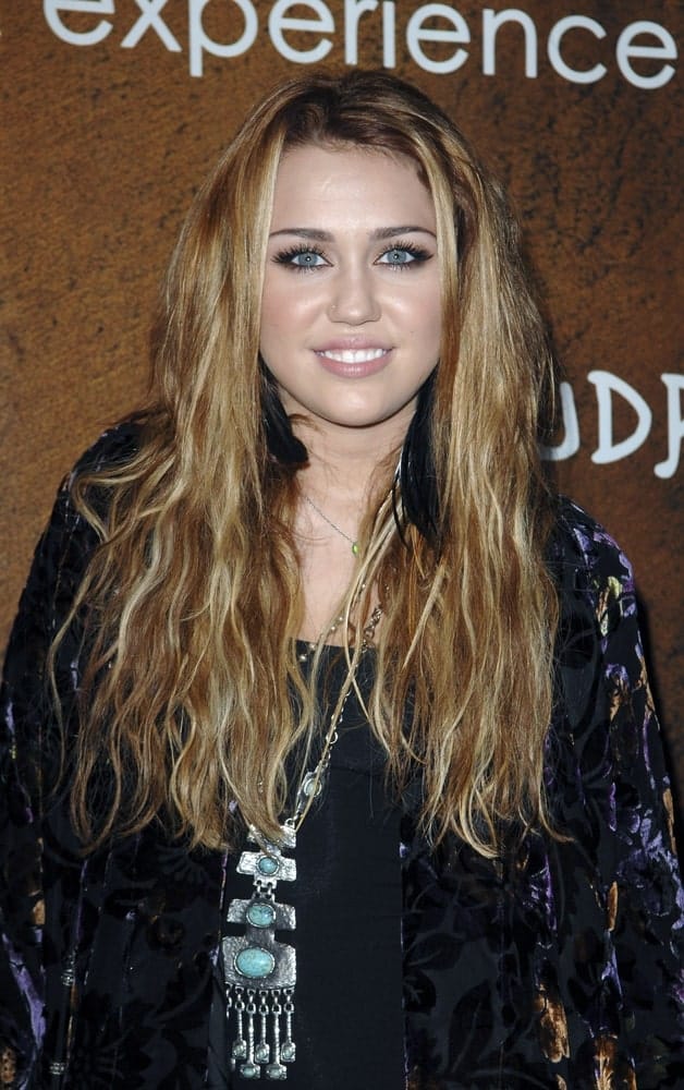 Miley Cyrus went with a loose and tousled wavy sandy blond hairstyle to go with her casual outfit at the Grand Opening of XANDROS Greek Restaurant, 50 North La Cienega in Beverly Hills, CA on October 7, 2010.