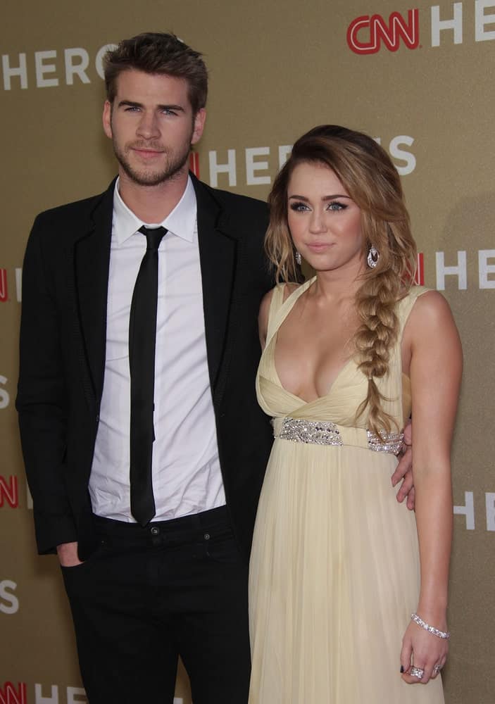 Miley Cyrus and Liam Hemsworth attended the CNN Heroes: All-Star Tribute 2011 on December 11, 2011 in Los Angeles, CA. Cyrus wore a sweet yellow dress that she complemented with a tousled side-swept hairstyle with fishtail braid on the side.