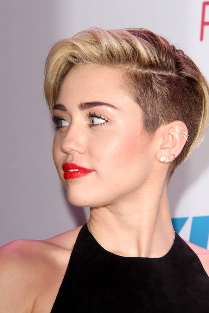 Miley Cyrus paired her black dress with sexy bold red lips and a pixie hairstyle with an undercut finish at the KIIS FM Jingle Ball 2013 at Staples Center on December 6, 2013 in Los Angeles, CA.