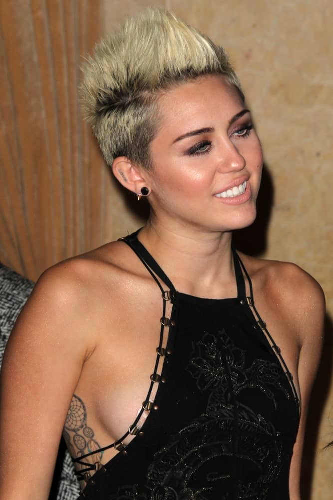 Miley Cyrus wore a stunning black dress that totally complemented her spiked highlighted pixie hairstyle when she arrived at the Clive Davis 2013 Pre-GRAMMY Gala at the Beverly Hilton Hotel on February 9, 2013 in Beverly Hills, CA.