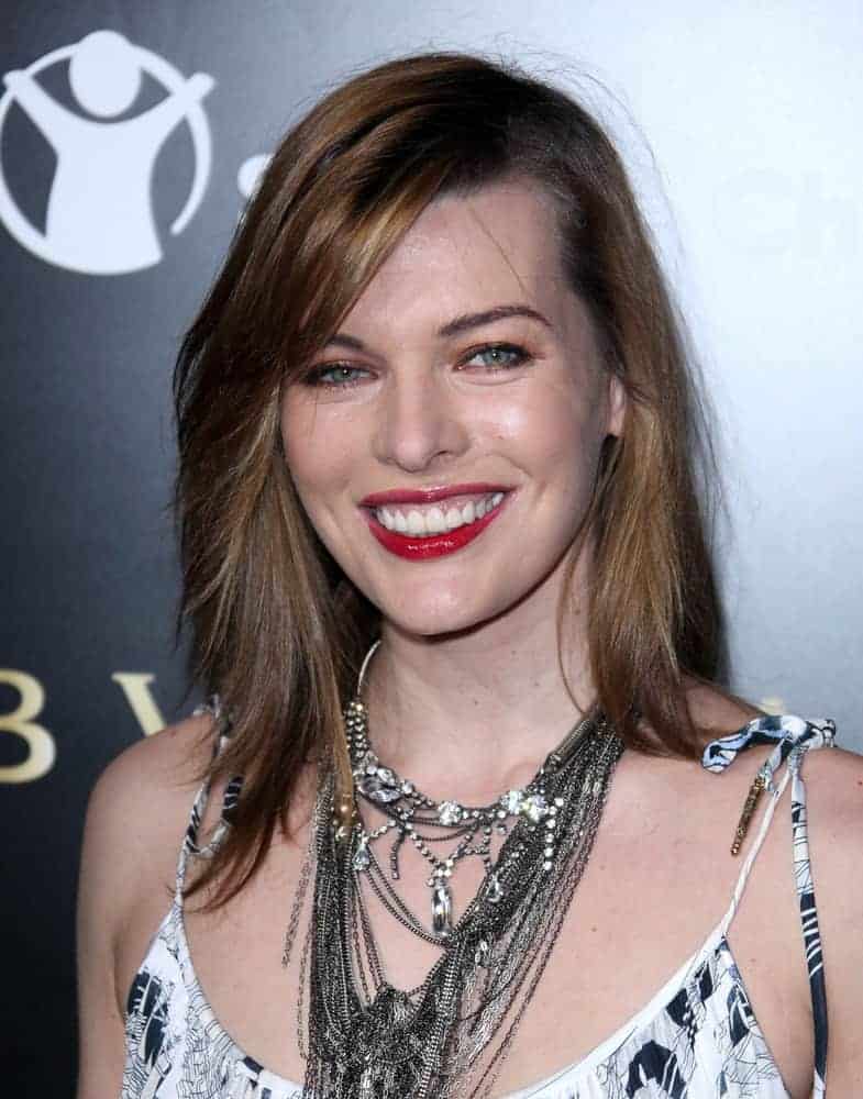 Milla Jovovich was at the Bvlgari Hosts Fundraiser for Save The Children on January 13, 2011, in Los Angeles, CA. She paired her black and white dress with a medium-length brunette hairstyle that is layered and tousled.