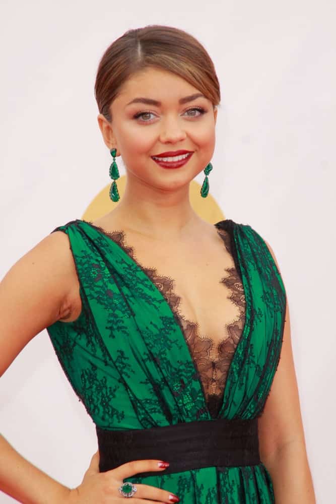 Sarah Hyland attended the 65th Primetime Emmy Awards at the Nokia Theatre, LA Live on September 22, 2013 Los Angeles, CA. She wore a sexy green dress to match her jade earrings and slick highlighted bun hairstyle that has side-swept bangs.