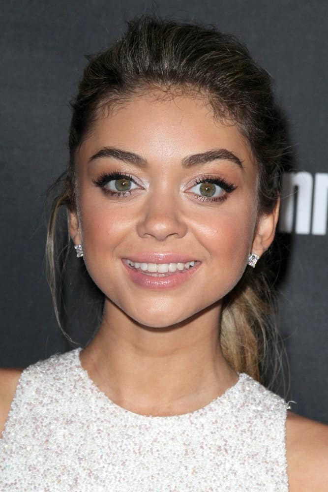 Sarah Hyland was at the 2014 Entertainment Weekly Pre-Emmy Party at Fig & Olive on August 23, 2014 in West Hollywood, CA. She paired her bedazzled dress and diamond earrings with a simple ponytail hairstyle with loose tendrils.