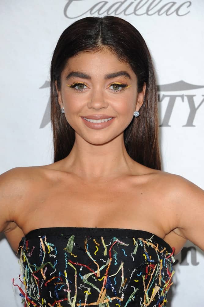 Sarah Hyland was at the Variety And Women In Film's 2018 Pre-Emmy Celebration held at the Cecconi's in West Hollywood on September 15, 2018. She wore a colorful strapless dress with her simple makeup and long straight and slick brunette hairstyle.