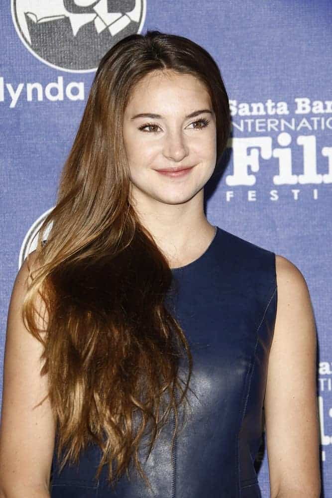 Shailene Woodley was at the 27th annual Santa Barbara Film Festival Virtuosos Award Ceremony at the Arlington Theater on February 3, 2012, in Santa Barbara, California. She was seen wearing a navy blue leather dress to pair with her side-swept long highlighted brunette hairstyle with layers.