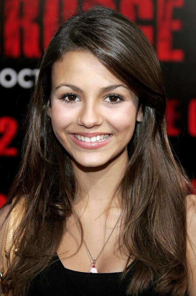 On October 8, 2006, in Buena Park, Victoria Justice attends the World Premiere of "The Grudge 2" held at the Knott's Berry Farm in Buena Park, California. She wore a black blouse with her long and layered brunette hairstyle with long side-swept bangs.