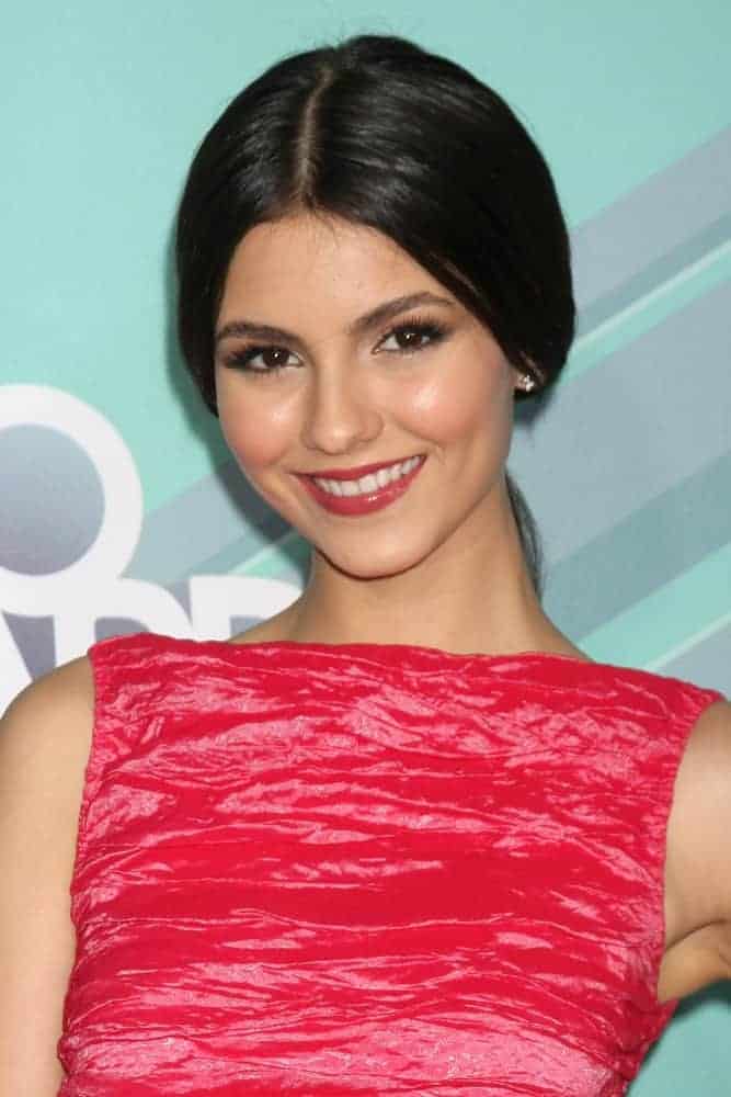 Victoria Justice wore a bright red dress at the 2011 Nickelodeon TeenNick HALO Awards at Hollywood Palladium on October 26, 2011, in Los Angeles, CA. She paired this with a slick raven ponytail hairstyle.