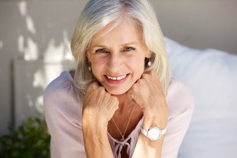 Woman over 50 with medium-length hair parted to the side.