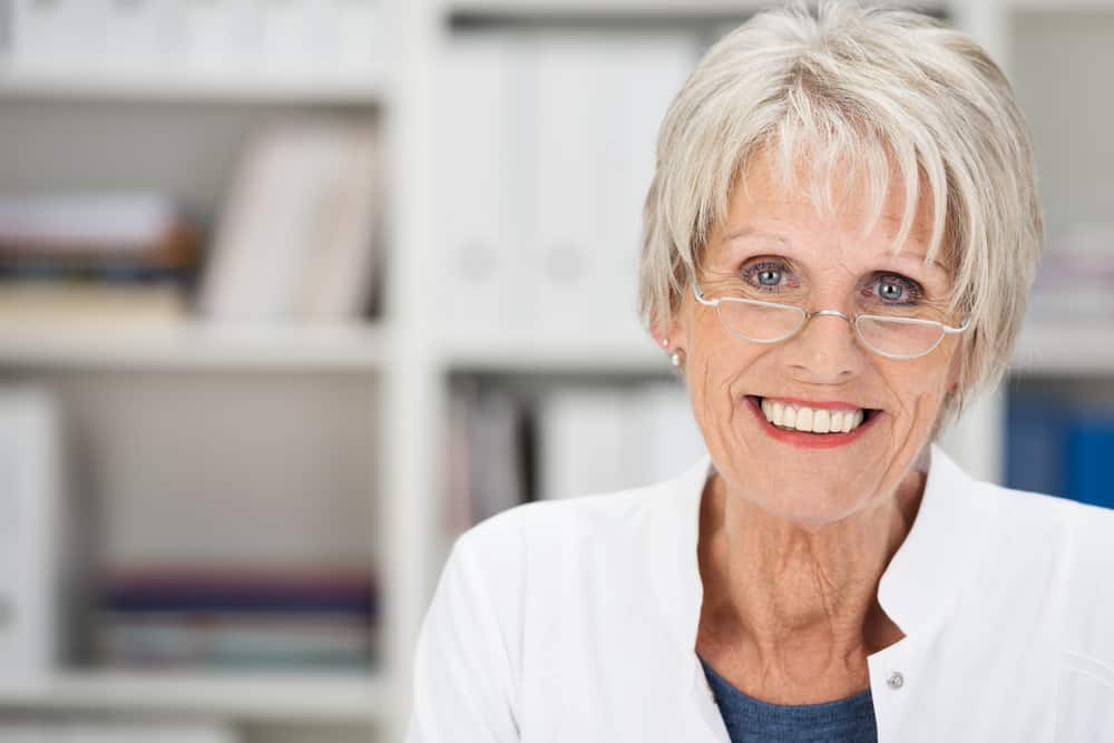 Woman with gray short haircut wearing glasses