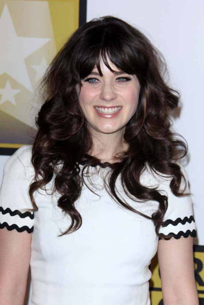 Zooey Deschanel was at the 1st Annual Critics' Choice Television Awards at Beverly Hills Hotel on June 20, 2004, in Beverly Hills, CA. She paired her sexy white dress with a long and tousled dark hairstyle that has bangs and spiral curls.