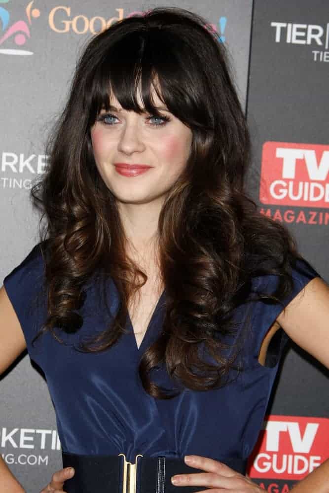 Zooey Deschanel attended the TV Guide Magazine Hot List Party at the Greystone Manor on November 7, 2011, in Los Angeles, CA. She wore a charming blue dress with her long and tousled dark hairstyle that has spiral curls and layers.