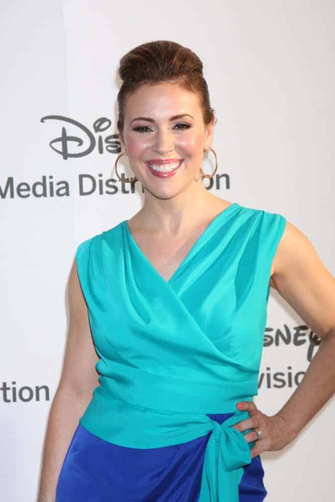 This celeb is wearing a classic pompadour bun at the ABC / Disney International Upfronts on May 20, 2012. She paired it with hoop earrings and a two-toned wrap around dress.