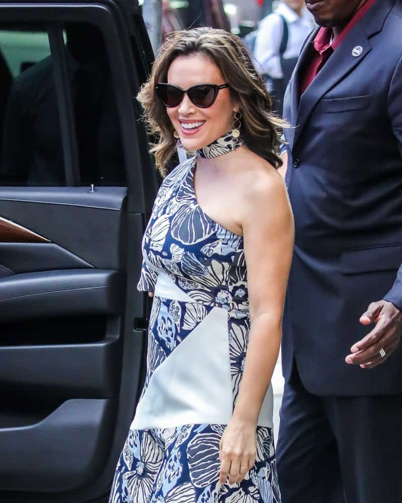 Alyssa Milano was spotted on August 6, 2018 in New York City wearing a floral print dress and black shades along with her tousled highlighted waves.