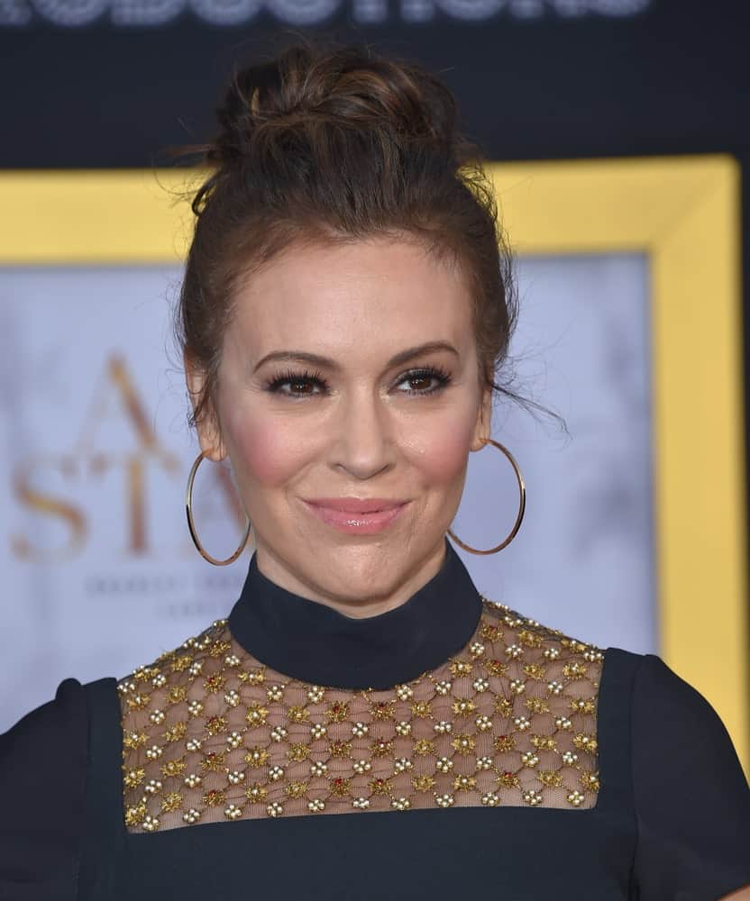 Alyssa Milano wore a messy upstyle hairstyle emphasizing her hoop earrings and turtleneck dress at the "A Star Is Born" Los Angeles Premiere on September 24, 2018.