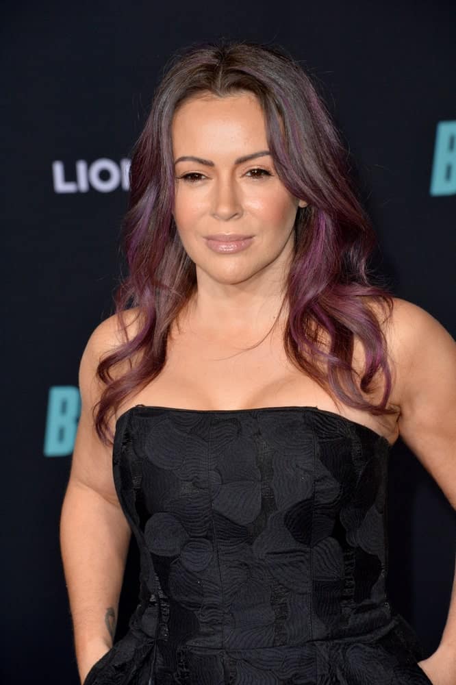 Alyssa Milano showcased a center-parted wavy hairstyle that's accentuated with purple hues during the premiere of "Bombshell" at the Regency Village Theatre on December 11, 2019.