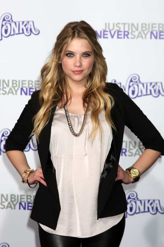 Ashley Benson arrived at the premiere of Paramount Pictures' Justin Bieber: Never Say Never at Nokia Theater L.A. Live on February 8, 2011 in Los Angeles, CA. She wore a black jacket on her casual outfit paired with a loose, tousled and layered half-up sandy blonde hairstyle with beach waves and highlights.