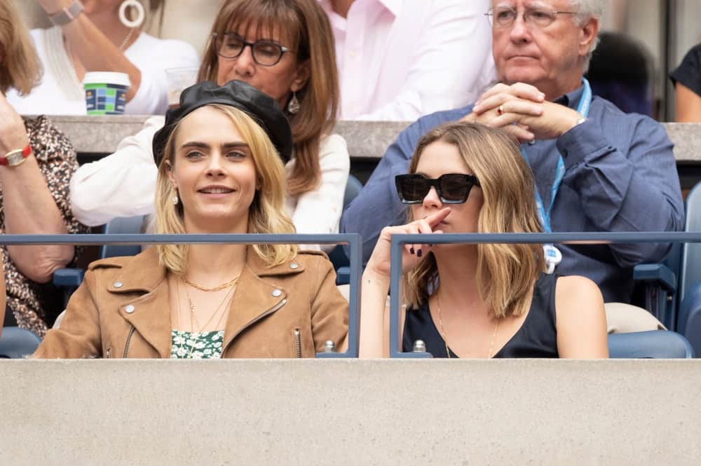 On Sep 7, 2019, Cara Delevingne and Ashley Benson attended the US Open womens final at Billie Jean King Tennis Center. Benson wore a casual blouse with her shoulder-length layered and loose blond hairstyle.