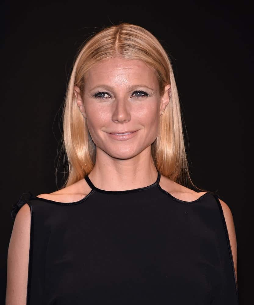 Gwyneth Paltrow complemented her cold shoulder dress with a sleek center-parted hairstyle in straight blonde at the Tom Ford Autumn/Winter 2015 Womenswear Collection Presentation held on February 20th.