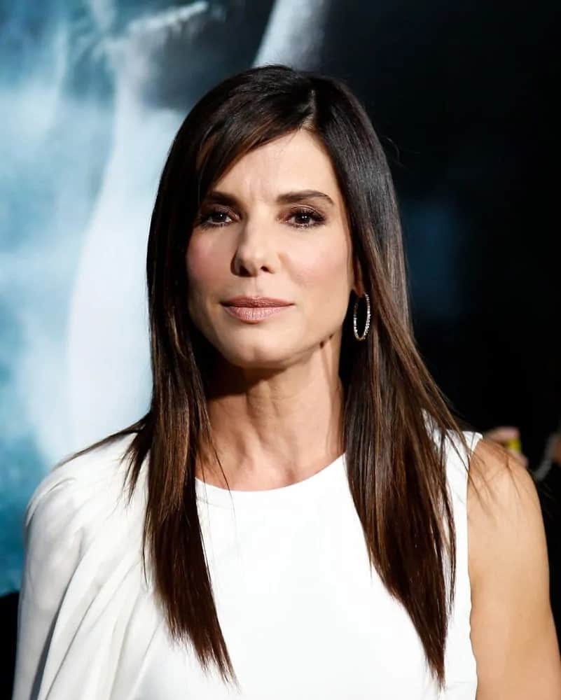 Sandra Bullock had long and straight layers with a side part hairstyle that complemented her white dress at the 'Gravity' premiere last October 1, 2013.