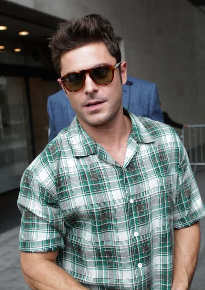 The actor was spotted at the BBC Radio One Studios at Broadcasting House on Aug 11, 2015 wearing a green plaid polo shirt along with a brushed up hairstyle.
