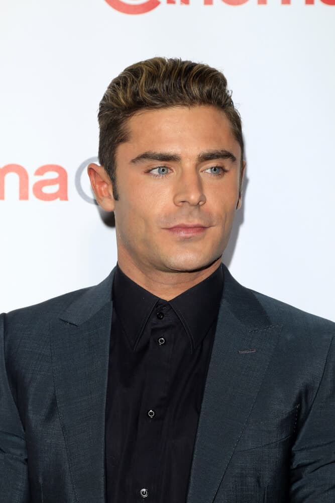 Zac Efron at the CinemaCon Awards Gala at the Caesars Palace on April 14, 2016 sporting his regular crew cut styled with highlighted brushed up hairdo.