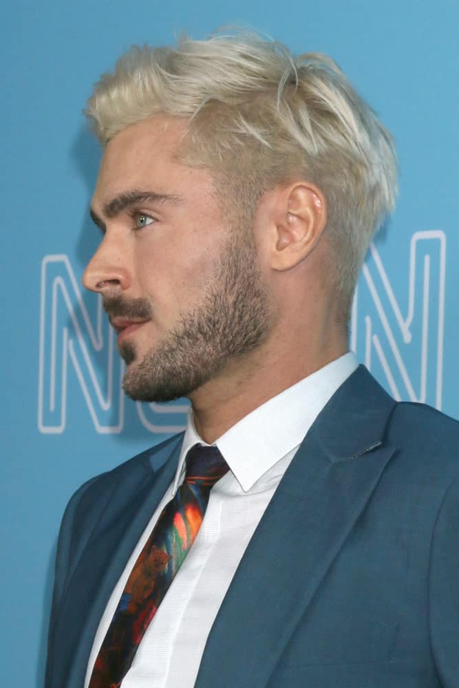Actor Zac Efron pulled off a fade haircut styled with frontal spikes during "The Beach Bum" Premiere at the ArcLight Hollywood on March 28, 2019.