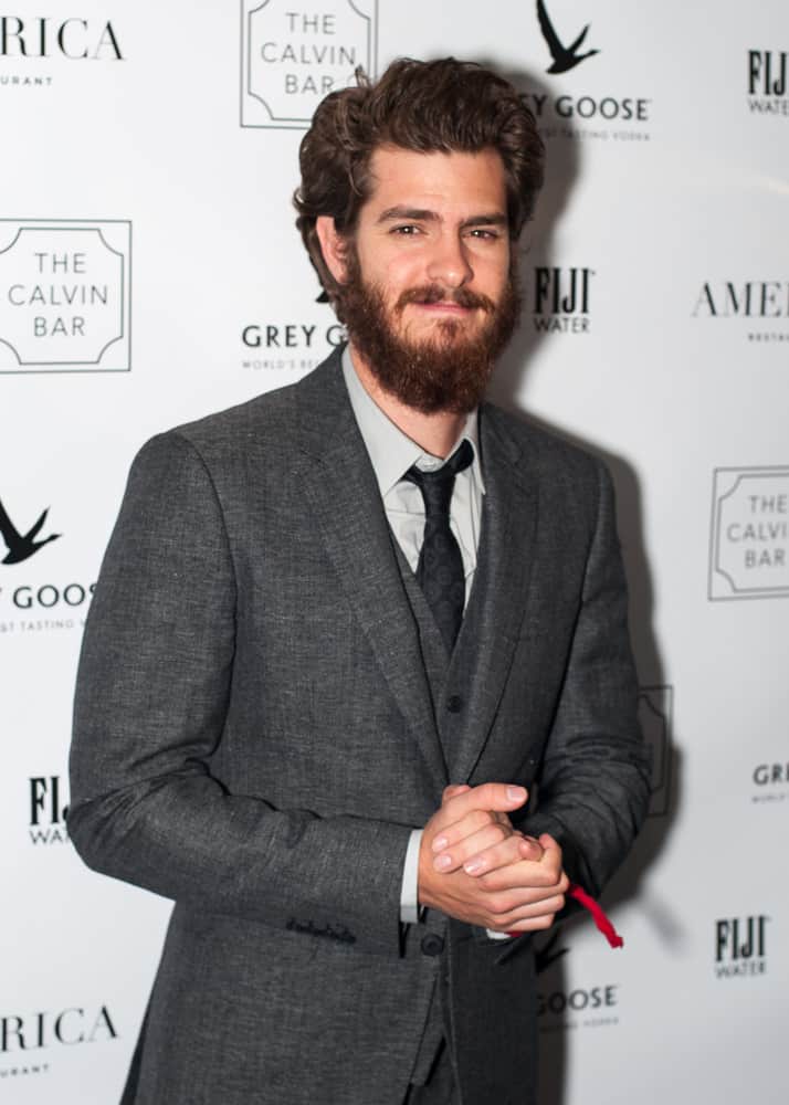 Andrew Garfield went for a longer side-swept 'do with a heavy bearded look during the America Restaurant afterparty for the film "99 Homes" in 2014.